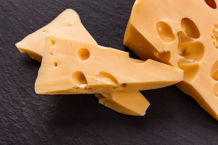 Piece and slices of cheese on a white background.の写真素材