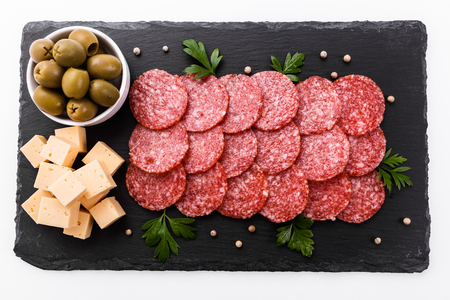delicious sliced salami on a stone plate.の写真素材