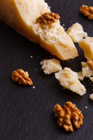fragrant Parmesan on a slate stone slicing board.の写真素材