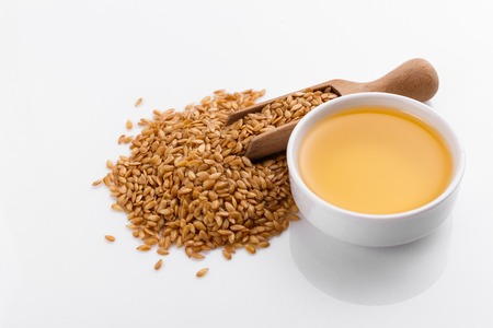 Seeds of golden flax on a white background.の写真素材