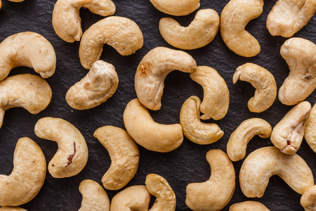cashew nuts on a dark stone background.の写真素材