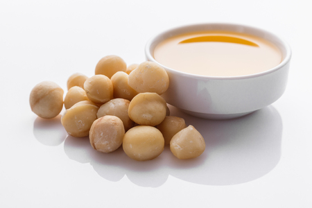 delicious macadamia nuts on a white acrylic background.の写真素材