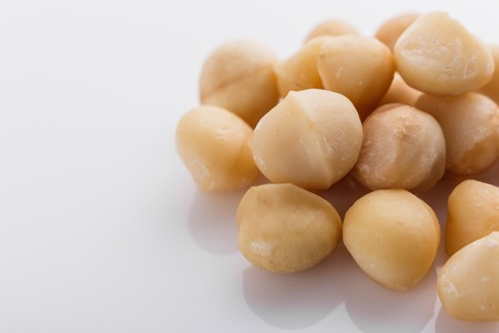 delicious macadamia nuts on a white acrylic background.の写真素材