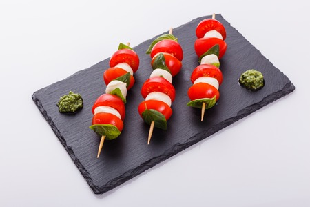 Caprese salad on a white acrylic background.の写真素材