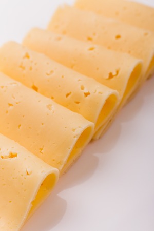 Piece and slices of cheese on a white background.の写真素材