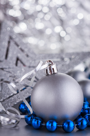 Christmas composition of Christmas tree toys on a blurred silver background.の写真素材