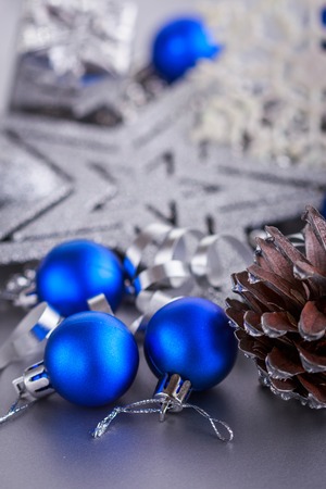 Christmas composition of Christmas tree toys on a blurred silver background.の写真素材