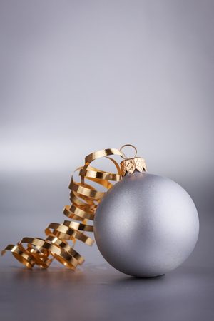 Christmas composition of Christmas tree toys on a blurred silver background.の写真素材
