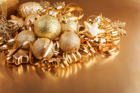 Christmas composition of Christmas tree toys on a blurred gold background.の写真素材