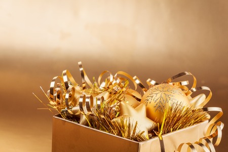 Christmas composition of Christmas tree toys on a blurred gold background.の写真素材