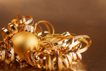 Christmas composition of Christmas tree toys on a blurred gold background.の写真素材