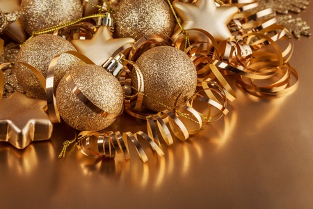 Christmas composition of Christmas tree toys on a blurred gold background.の写真素材