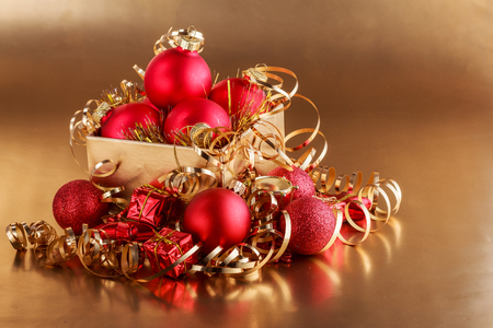 Christmas composition of Christmas tree toys on a blurred gold background.の写真素材
