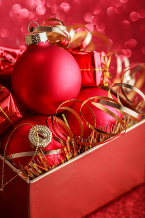 Christmas composition of Christmas tree toys on a blurred red background.の写真素材