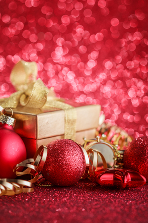 Christmas composition of Christmas tree toys on a blurred red background.の写真素材
