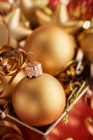 Christmas composition of Christmas tree toys on a blurred red background.の写真素材