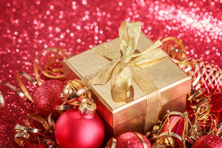 Christmas composition of Christmas tree toys on a blurred red background.