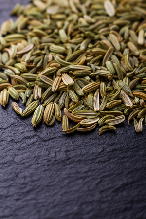 fennel seeds on a dark stone background.の写真素材
