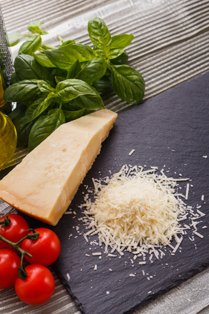 fragrant grated Parmesan on a slate stone slicing board.の写真素材
