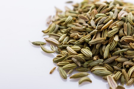 essential oil of fennel seeds on a white background.の写真素材