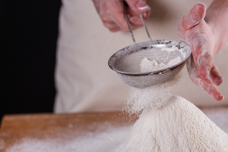 young woman squirting a flour in an apron.の写真素材