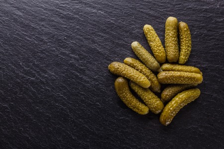 pickled vegetables on a dark stone background.の写真素材