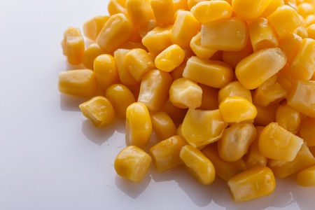 Canned corn on a white acrylic background.の写真素材
