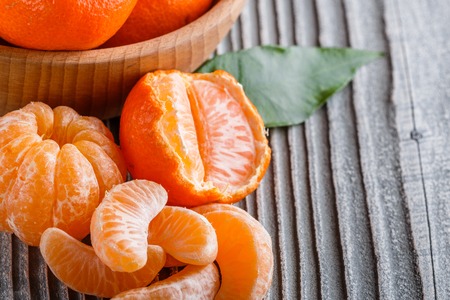 juicy mandarin on a gray wooden rustic background.の写真素材