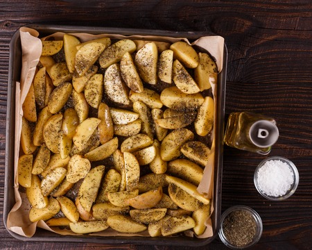 potato flavored with spices on a dark background.の写真素材