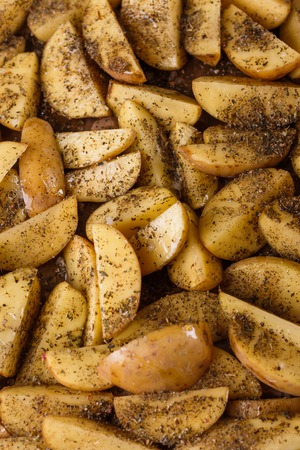 potato flavored with spices on a dark background.の写真素材