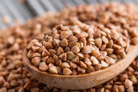 Grain buckwheat on a gray wooden background.の写真素材