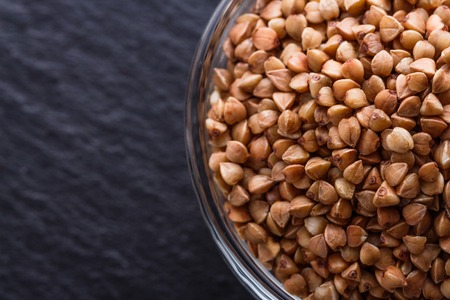 Grain buckwheat on a dark stone background.の写真素材