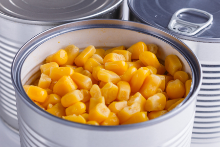 Canned corn in a iron can on white background.の写真素材