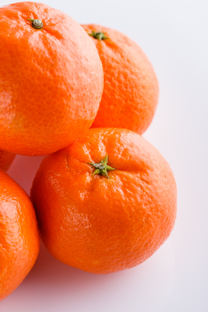 juicy mandarin on a white acrylic background.の写真素材