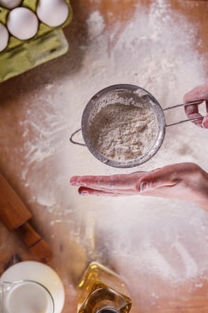 young woman squirting a flour in an apron.の写真素材
