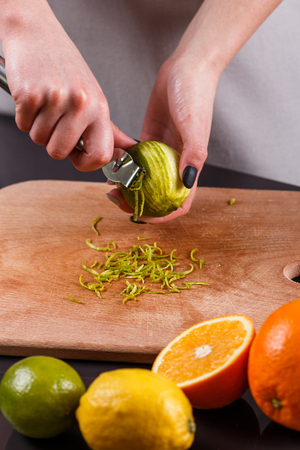 young woman in a gray aprons cut cedar lime
