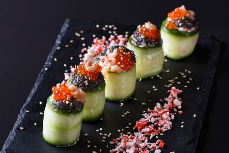 rolls covered in cucumber with caviar and prawn.の写真素材