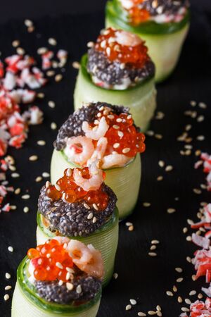 rolls covered in cucumber with caviar and prawn.の写真素材