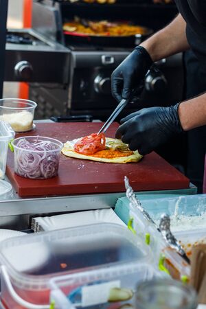 chef cooks tacos at the street food festival.の写真素材
