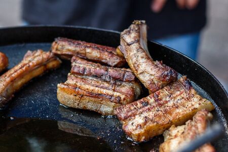 chef cooks ribs at the street food festival.の写真素材
