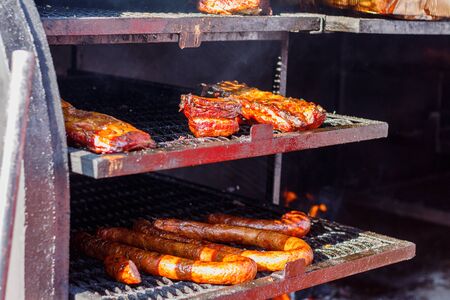 meat and vegetables in large BBQ grill at street food festival.の写真素材