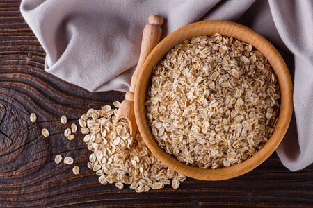 raw oatmeal on a wooden rustic background.の写真素材