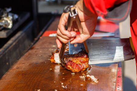 chef cooks ribs at the street food festival.の写真素材