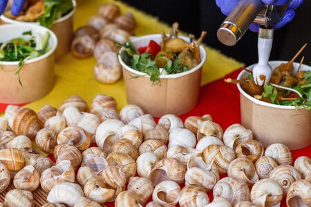 snails at the counter of the street food festival.の写真素材
