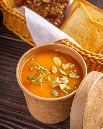 pumpkin cream soup on rustic wooden background.の写真素材