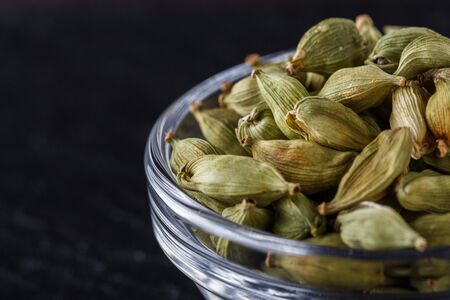 fragrant green cardamom on a dark stone background.の写真素材