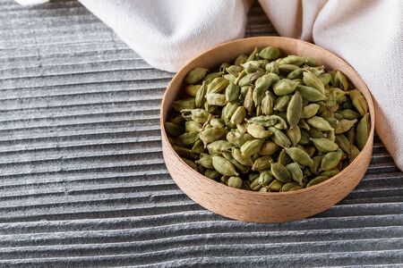 fragrant green cardamom on a wooden rustic background.の写真素材
