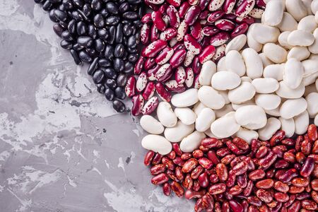 Fresh organic natural beans on stone background.