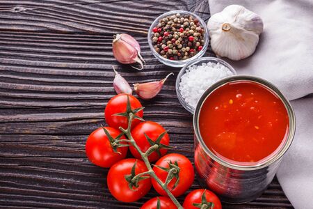 juicy canned tomatoes on wooden rustic background.の写真素材