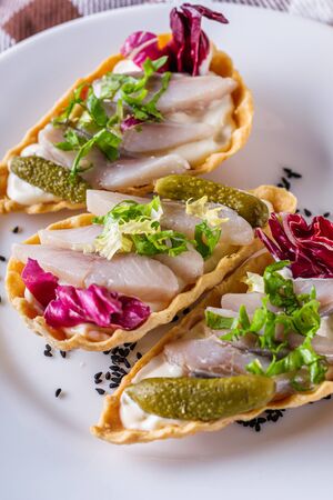 delicious snack tartlets on rustic wooden background.の写真素材